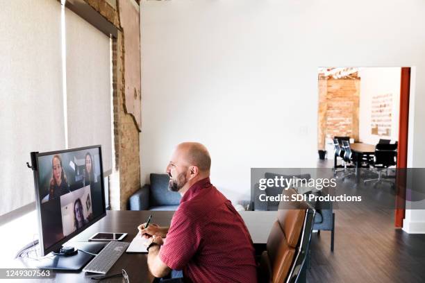 cheerful businessman talks with colleagues during video chat - virtual teamwork stock pictures, royalty-free photos & images