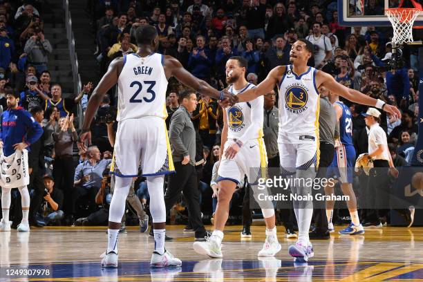 Draymond Green and Jordan Poole of the Golden State Warriors high five during the game against the Philadelphia 76ers on March 24, 2023 at Chase...
