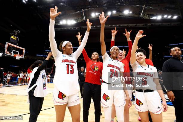 Merissah Russell, Morgan Jones and Mykasa Robinson of the Louisville Cardinals celebrate after defeating the Ole Miss Rebels during the Sweet Sixteen...