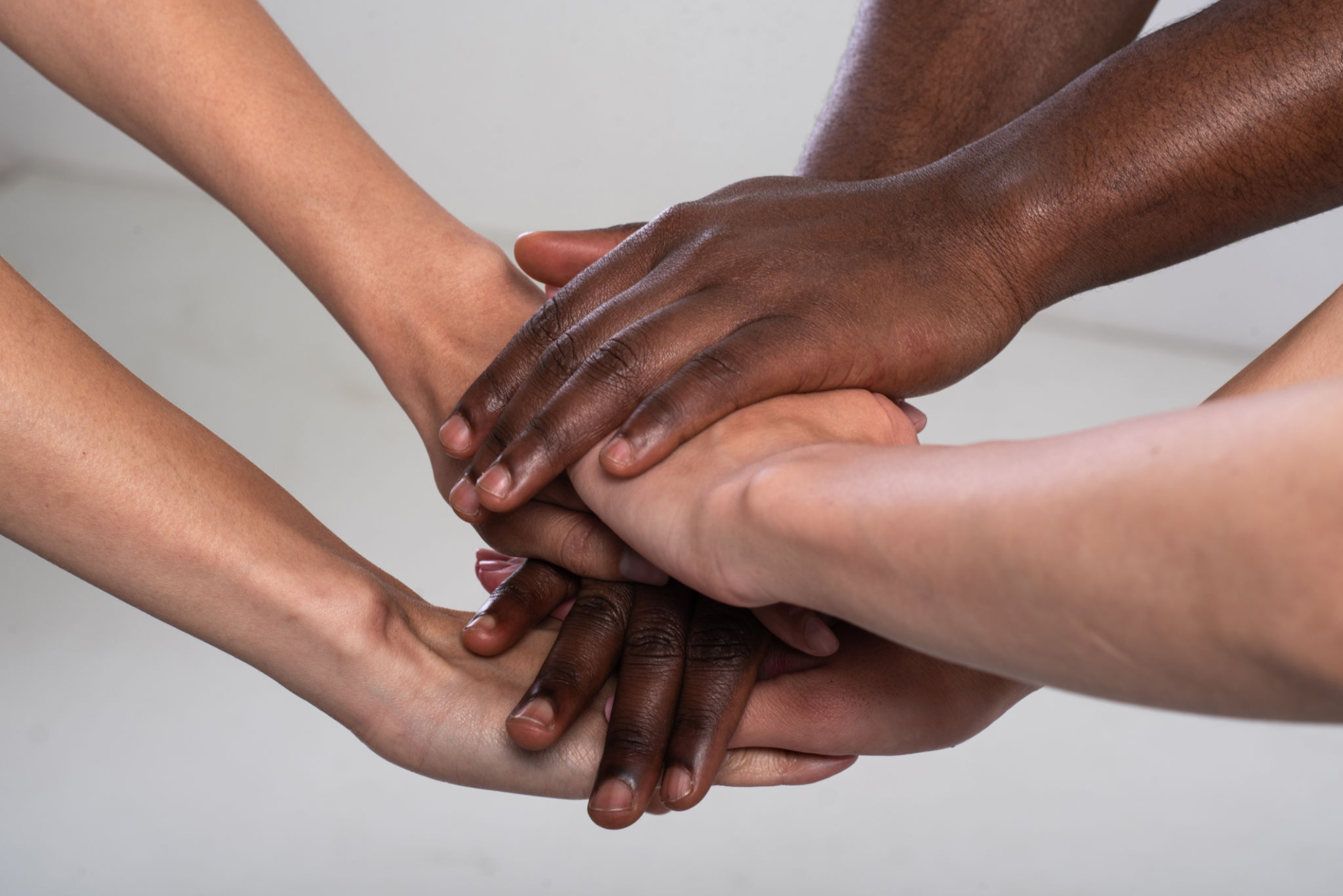 Anti racist studio shot of unrecognizable group of people holding hands Anti racist studio shot of unrecognizable group of people holding hands