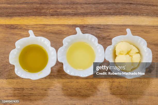 diversity of cooking fats over a wood background - canola oil stock pictures, royalty-free photos & images