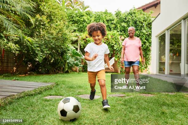 having fun playing football with grandma - brazil and outside and ball stock pictures, royalty-free photos & images