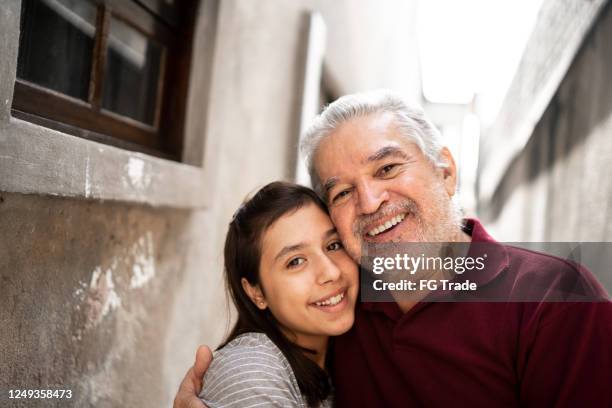 portrait of grandfather and granddaughter at home - grandfather face stock pictures, royalty-free photos & images