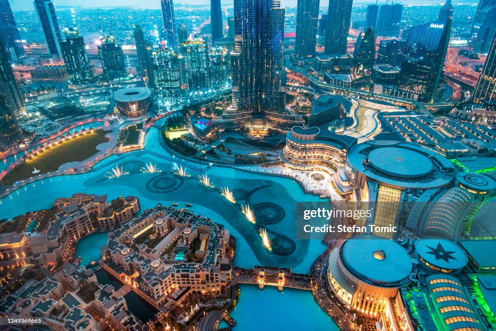 Dubai mall fountain show at night Burj khalifa rising above