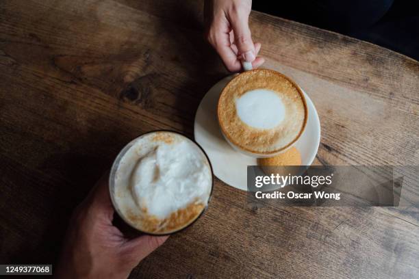 concept of couple in love having coffee at the cafe - cappuccino stock pictures, royalty-free photos & images