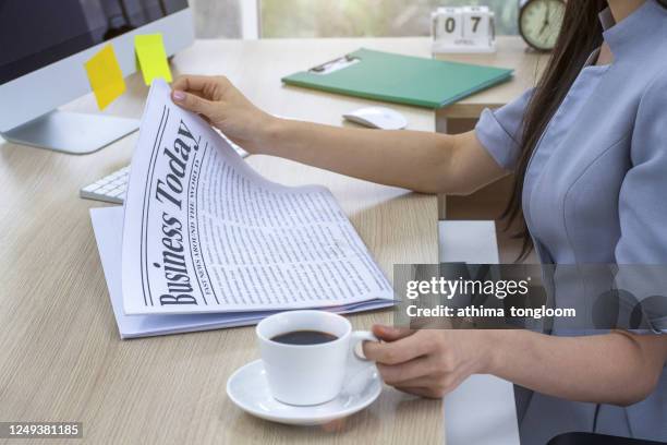 businesswoman reading a newspaper - ammunition magazine fotografías e imágenes de stock