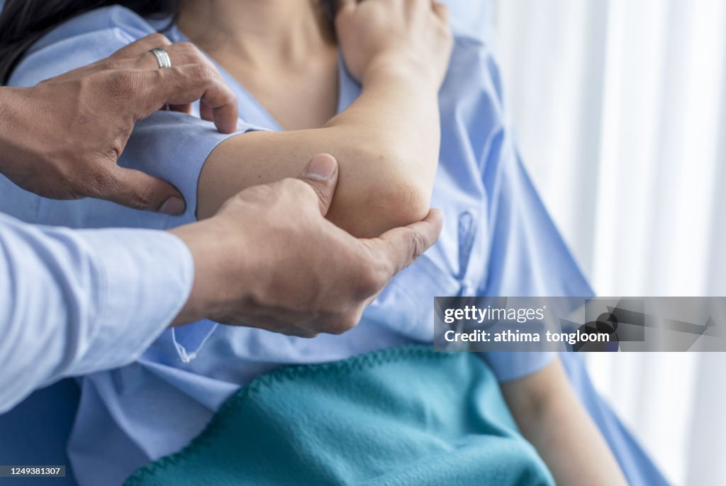 Orthopedist examining patient in hospital