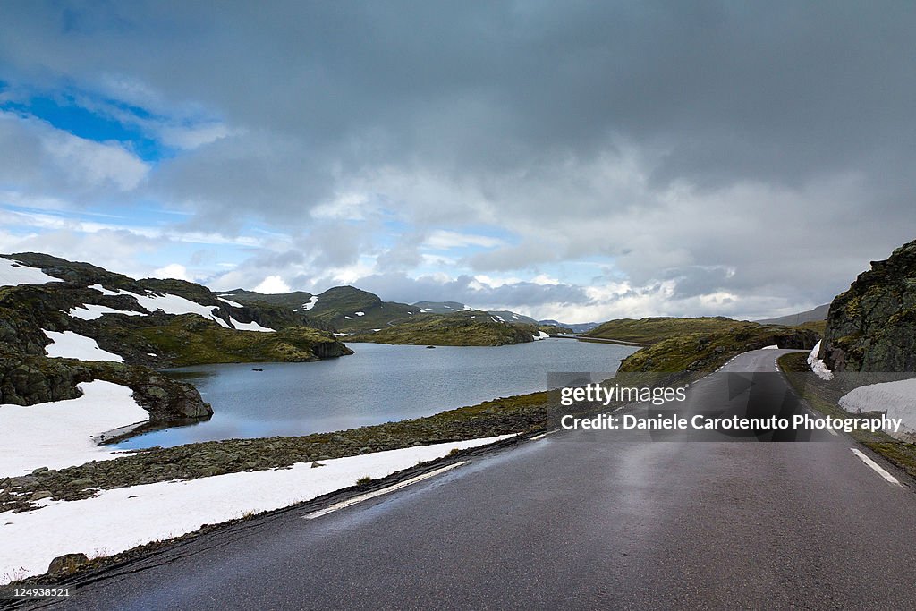 Road with snow mountains on both side