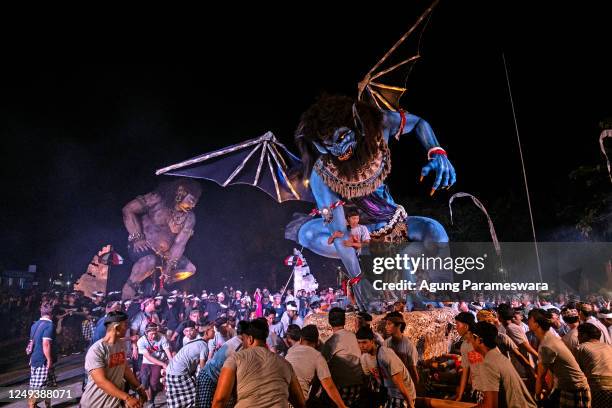 Balinese youth men carry the giant ogoh-ogoh during the parade in Pengerepukan, a day before Nyepi day on March 21, 2023 in Gianyar, Bali, Indonesia....