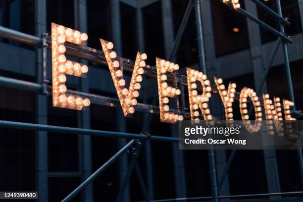 illuminated lightbulb sign in the city at night - abc entertainment stock pictures, royalty-free photos & images