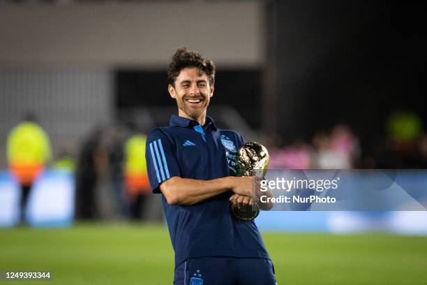 Argentina?s Pablo Aimar celebrates with the World Cup trophy after an international friendly soccer match against Panama at the Monumental stadium in...