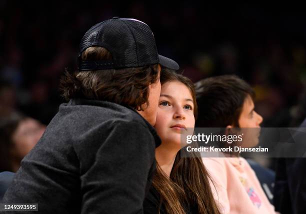 Jason Bateman kisses his daughter Francesca Nora Bateman as they attend the Oklahoma City Thunder and Los Angeles Lakers game at Crypto.com Arena on...