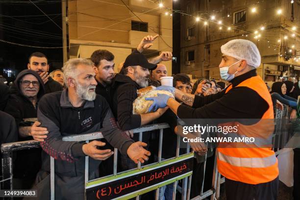 Charity volunteer hands out traditional Ramadan pre-dawn "Suhur" meals, the last meal consumed before the next day's fast during the Muslim holy...