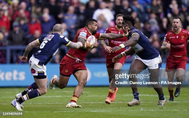 Catalans Dragons' Manu Ma'u holds off Leeds Rhinos' Justin Sangare during the Betfred Super League match at Headingley Stadium, Leeds. Picture date:...