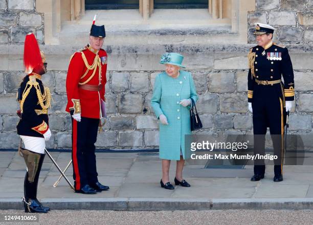 Queen Elizabeth II, accompanied by her equerry Lieutenant Colonel Nana Kofi Twumasi-Ankrah , Lieutenant Colonel Michael Vernon and Vice Admiral Tony...