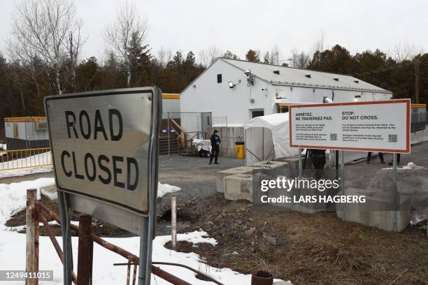 Royal Canadian Mounted Police officers guard the Roxham Road border crossing between the US and Canada in Champlain, New York, on March 25, 2023. -...