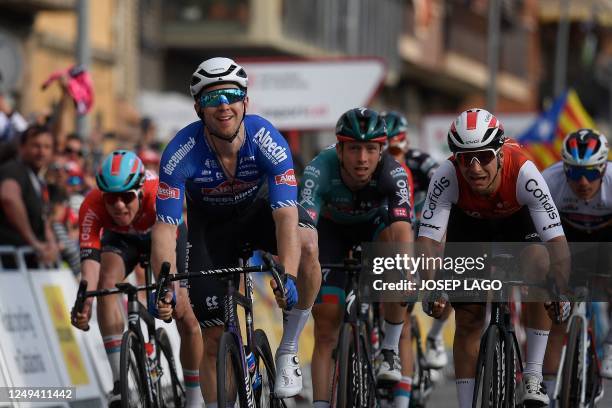 Stage winner Alpecin-Deceuninck's Australian rider Kaden Groves celebrates crossing the finish line of the 6th stage of the 2023 Volta Catalunya...