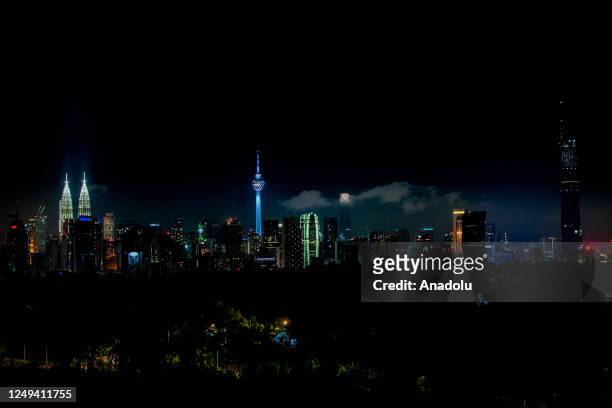 View of the KLCC Twin Towers and KL Tower before the main lights were turned off in conjunction with the "Earth Hour" 2023 event in Kuala Lumpur,...