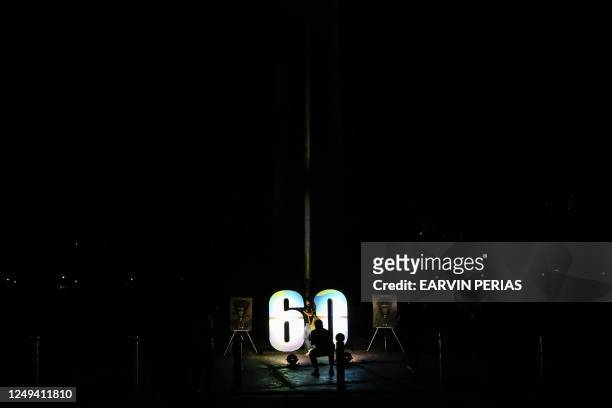 This picture shows the Quezon Memorial Shrine after the lights were turned off to mark the Earth Hour environmental campaign in Quezon city, suburban...
