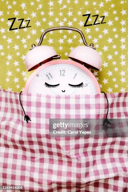 pink alarm clock sleeping in bed - daylight saving time stock pictures, royalty-free photos & images