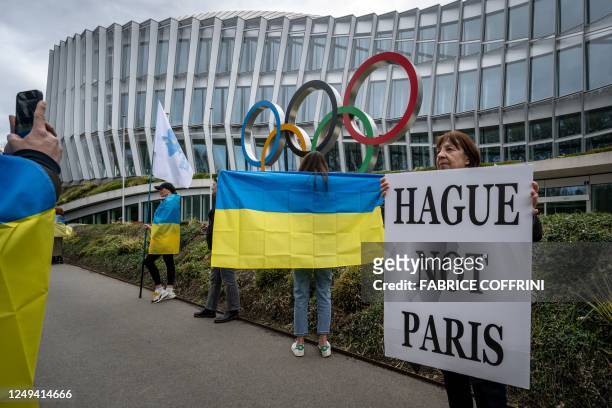 Ukrainians and supporters take part in a protest in front of the headquarters of International Olympic Committee against the proposed IOC roadmap to...