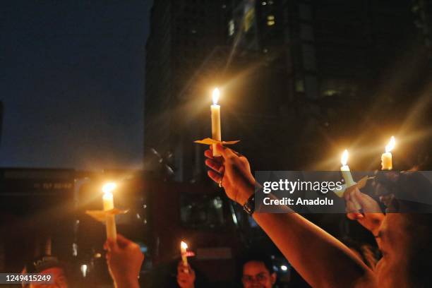 Volunteers Artha Graha Peduli light candle during Earth Hour at Sudirman Central Business District in Jakarta, Indonesia on March 25, 2023. Earth...