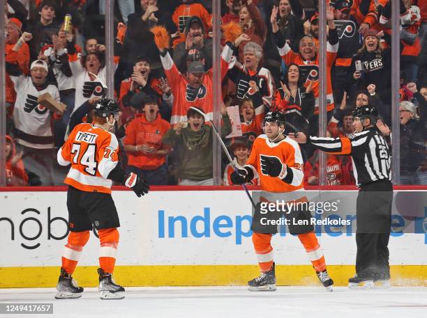 Referee Marc Joannette signals a good goal as Kieffer Bellows of the Philadelphia Flyers celebrates his second period goal against the Detroit Red...