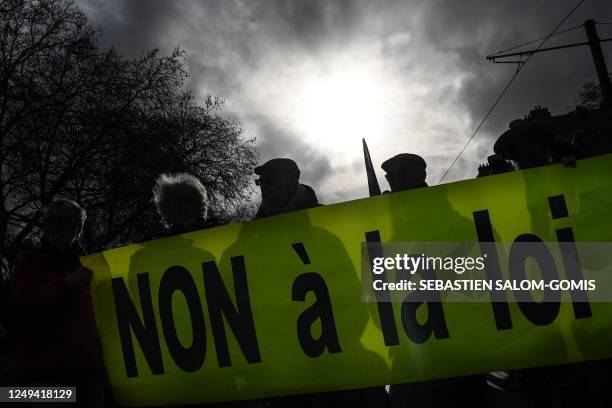 Protesters hold a banner reading "No to the law" during a protest against the Darmanin legislative proposal on immigration and the administrative...