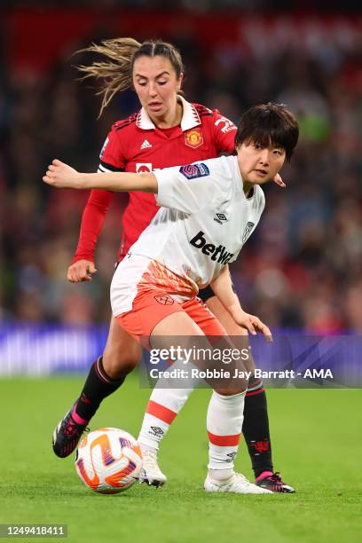 Honoka Hayashi of West Ham United Women tussles with Katie Zelam of Manchester United Women during the FA Women's Super League match between...