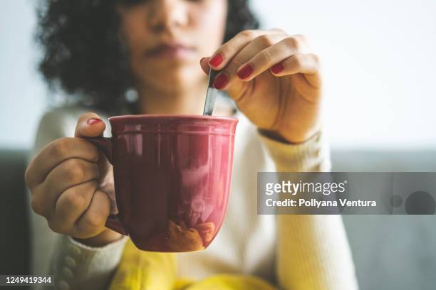 woman stirring coffee - hot latino girl stock pictures, royalty-free photos & images