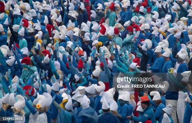 Participants dressed as Smurfs , a Belgian comic franchise centered on a fictional colony of small, blue, human-like creatures who live in...