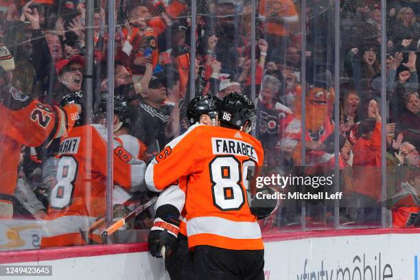 Scott Laughton of the Philadelphia Flyers celebrates with Joel Farabee after scoring a goal against the Detroit Red Wings in the second period at the...
