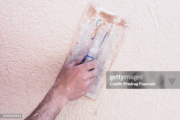 worker hand making new facade with space for text - verputz stock-fotos und bilder