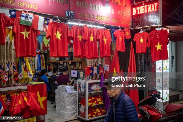 Shirts with Vietnam flag are on display in front of a store in the Old Quarter on March 25, 2023 in Hanoi, Vietnam. According to the General...