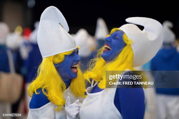 Women dressed as Smurfs , a Belgian comic franchise centered on a fictional colony of small, blue, human-like creatures who live in mushroom-shaped...