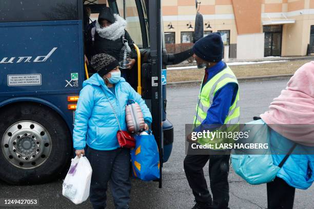 Refugges arrive at the Plattsburgh, New York, bus station before heading to the Roxham border crossing into Canada, on March 25, 2023. - The Roxham...