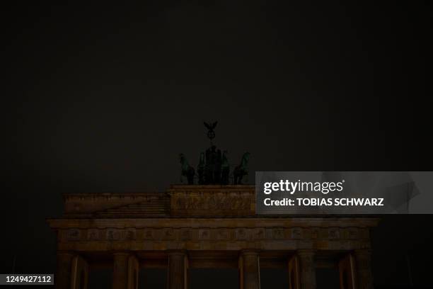 The lights of the Brandenburg Gate in Berlin are switched off during "Earth Hour" on March 25, 2023.