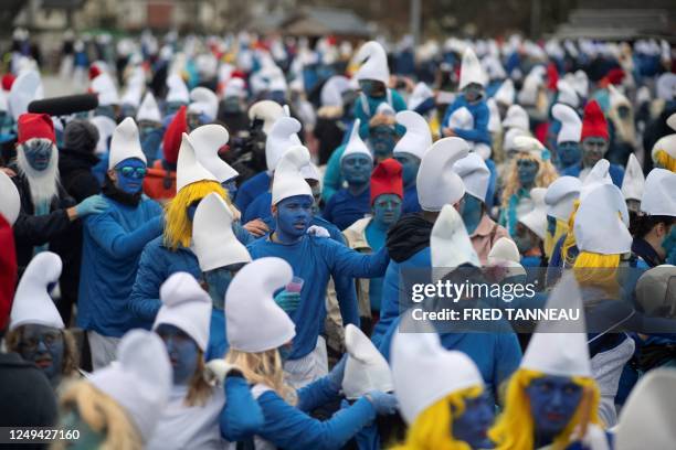 People dressed as Smurfs , a Belgian comic franchise centered on a fictional colony of small, blue, human-like creatures who live in mushroom-shaped...