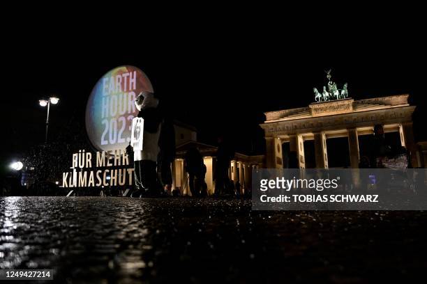 The Brandenburg Gate in Berlin is pictured during "Earth Hour" on March 25, 2023.