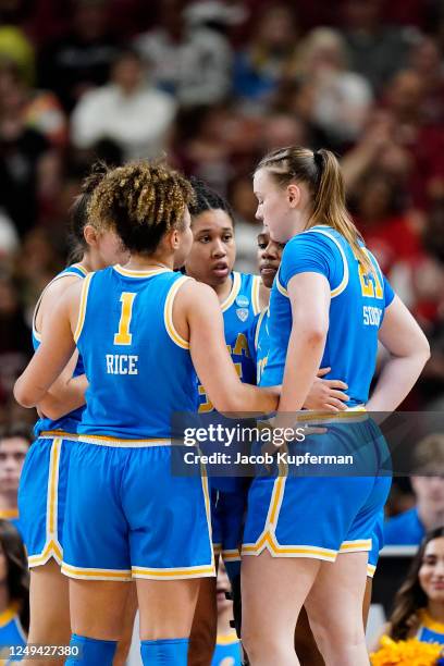 The UCLA Bruins in a huddle during the Sweet Sixteen round of the 2023 NCAA Womens Basketball Tournament held at Bon Secours Wellness Arena on March...