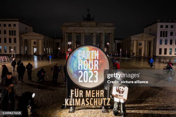 March 2023, International, Berlin: The lights at the Brandenburg Gate are switched off for the "Earth Hour" campaign. With the "Earth Hour" the...