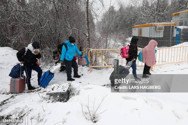 Refugees arrive at the Roxham Road border crossing in Champlain, New York, on March 25, 2023. - The Roxham Road crossing closed at midnight March 24,...