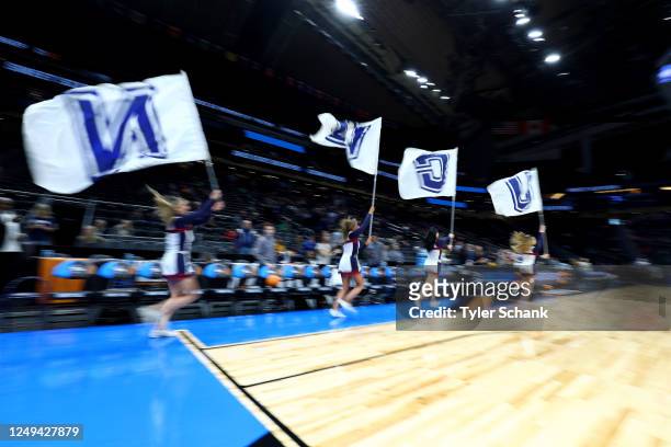 UConn Huskies cheerleaders carry flags as they run onto the court before the game against the Ohio State Buckeyes during the Sweet Sixteen round of...