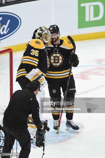 Linus Ullmark and David Krejci of the Boston Bruins celebrate the win against the Tampa Bay Lightning at the TD Garden on March 25, 2023 in Boston,...