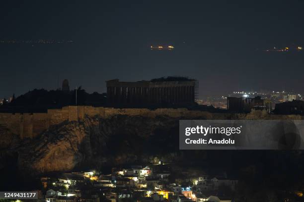 The ancient Parthenon temple is pictured atop the Acropolis Hill during Earth Hour in Athens, Greece on March 25, 2023.