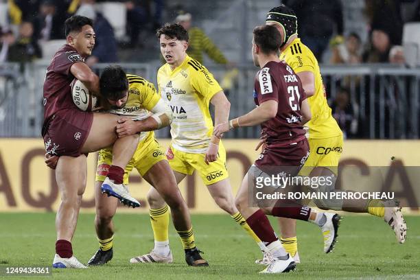Bordeaux' French centre Yoram Falatea Moefana is tackled during the French Top14 rugby union match between Union Bordeaux-Begles and Stade Rochelais...