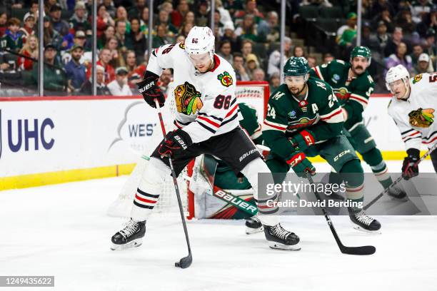 Mike Hardman of the Chicago Blackhawks skates with the puck while Matt Dumba of the Minnesota Wild defends in the second period of the game at Xcel...