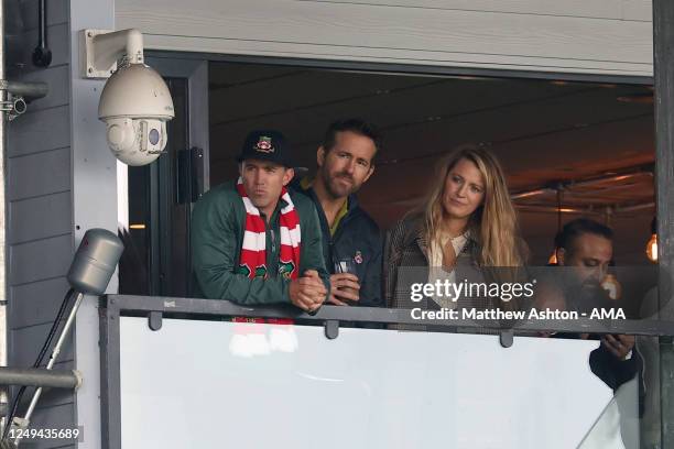 Wrexham owners Rob McElhenney watch the game with Ryan Reynolds and his wife Blake Lively during the Vanarama National League match between Wrexham...