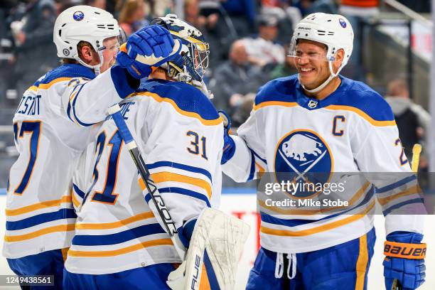 Casey Mittelstadt, Eric Comrie and Kyle Okposo of the Buffalo Sabres celebrate the 2-0 win against the New York Islanders at UBS Arena on March 25,...