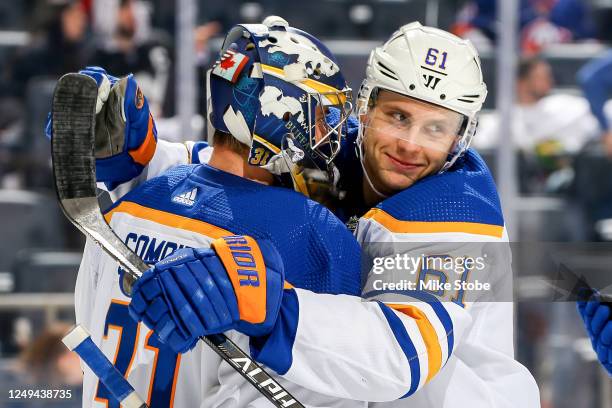 Eric Comrie and Riley Stillman of the Buffalo Sabres celebrate the 2-0 win against the New York Islanders at UBS Arena on March 25, 2023 in Elmont,...